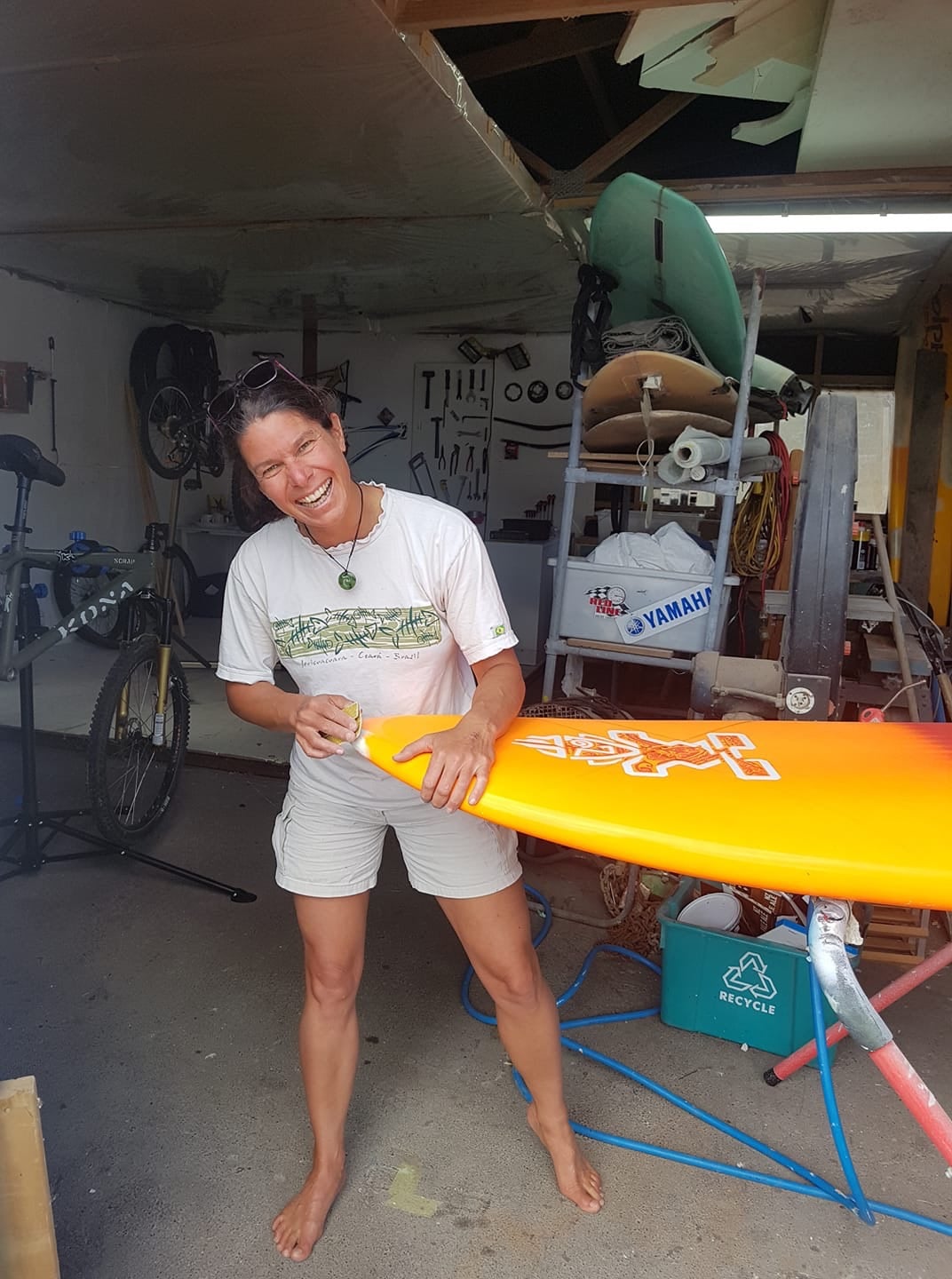 Woman repairing the nose of a windsurf board