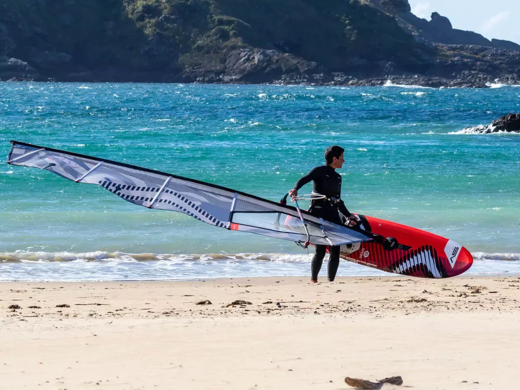 Windsurfer on the beach in Maitai Bay, New Zealand