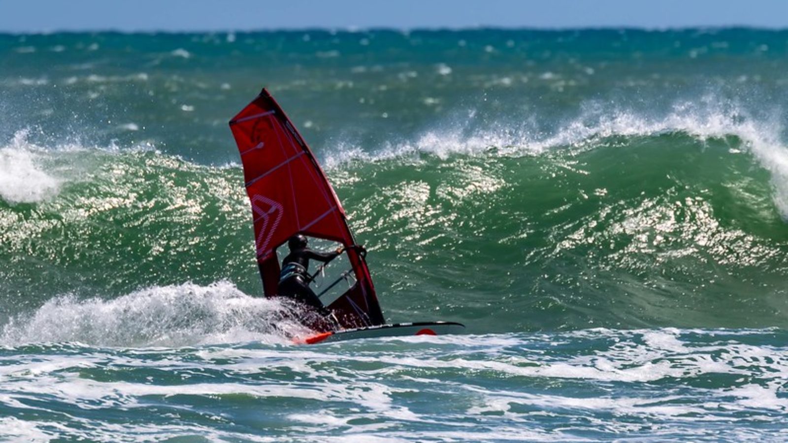 Windsurfer on a wave in Taranaki, New Zealand